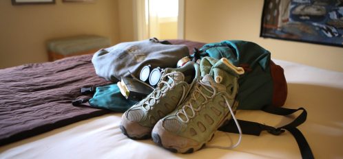 hiking equipment on bed