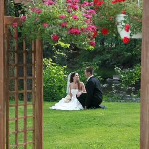 Weddings at Settlers Inn a couple kneel in the garden