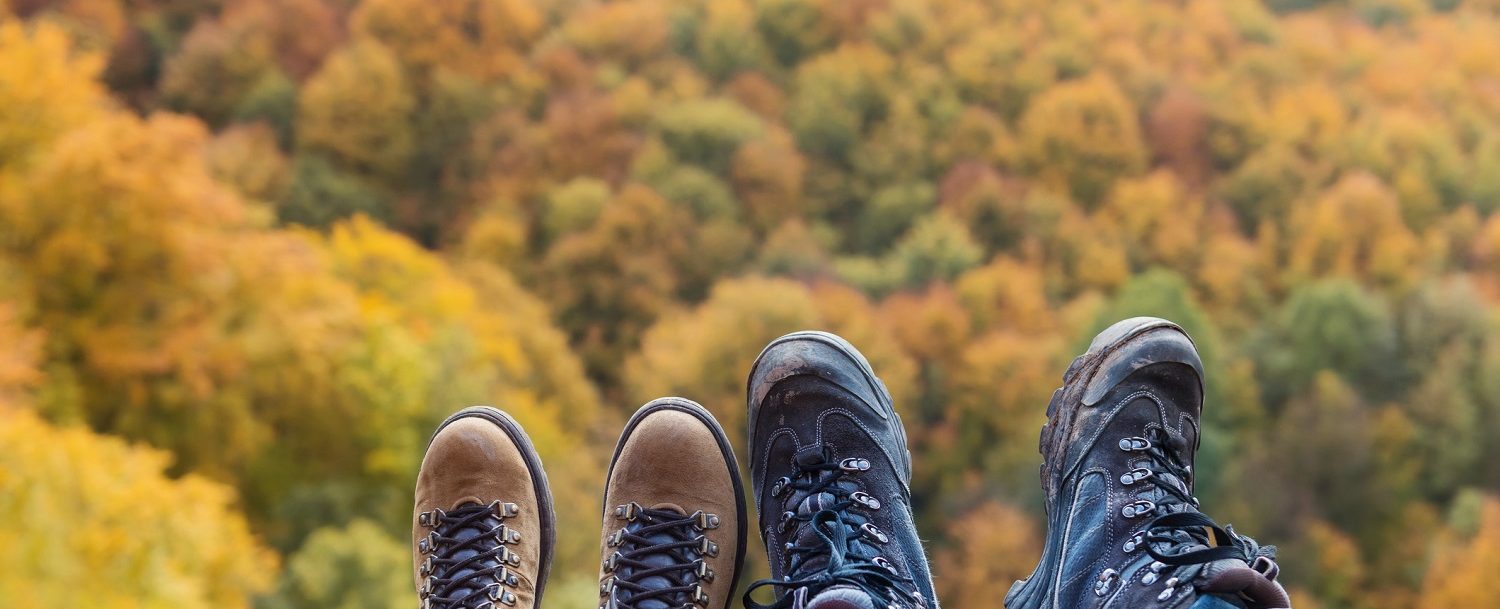 Couple wearing hiking boots sit together