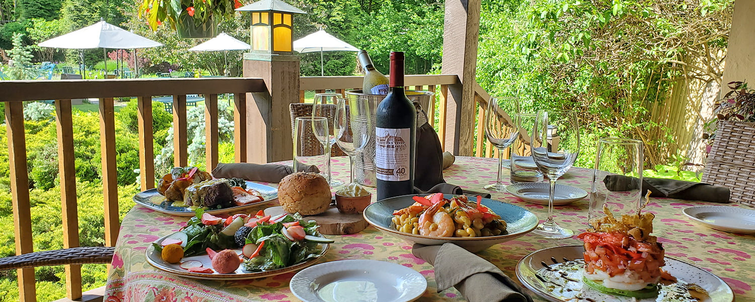 The Settlers Inn Restaurant outdoor spread of food with wine bottle